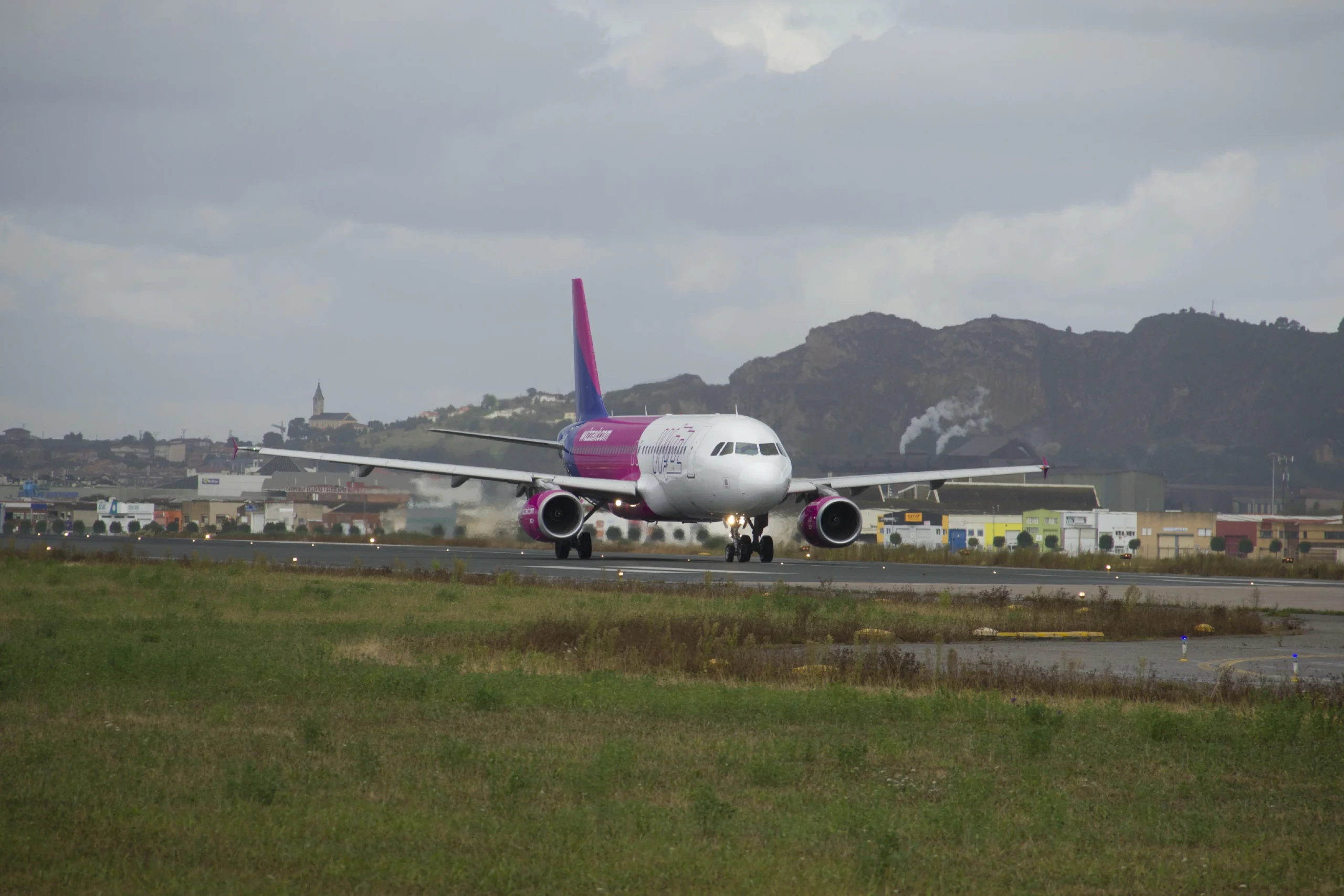 Wizz Air aircraft at London Luton Airport with terminal in background