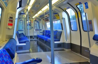 A London Underground train arriving at a subterranean station platform on the Tube network.