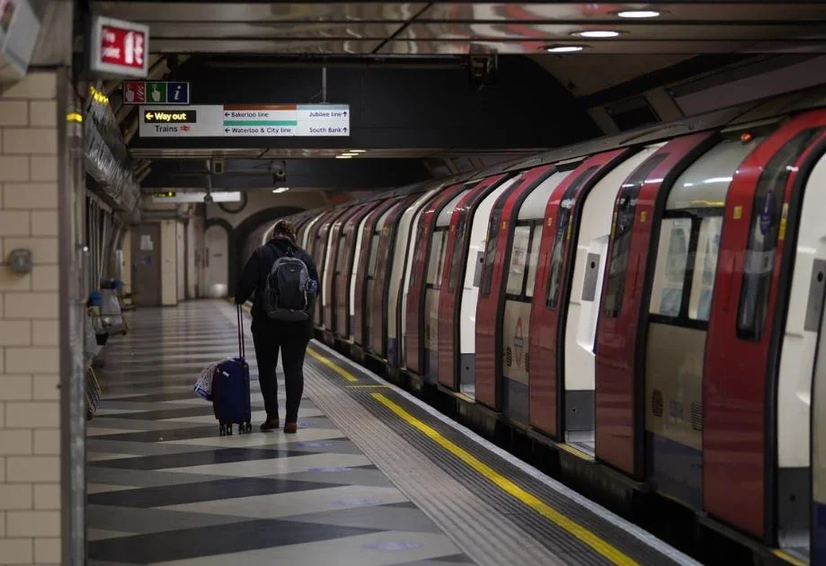 A London Underground Piccadilly line train with luggage