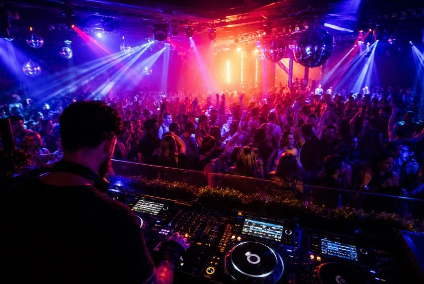 Crowd dancing under lights in a London nightclub