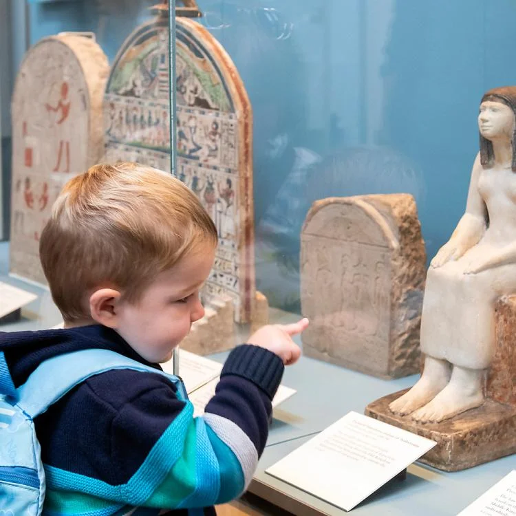 Children viewing British Museum mummy gallery.