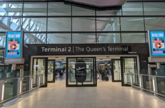 The entrance to Terminal 2 at London Heathrow, the Queen's Terminal, with its glass frontage and covered forecourt.