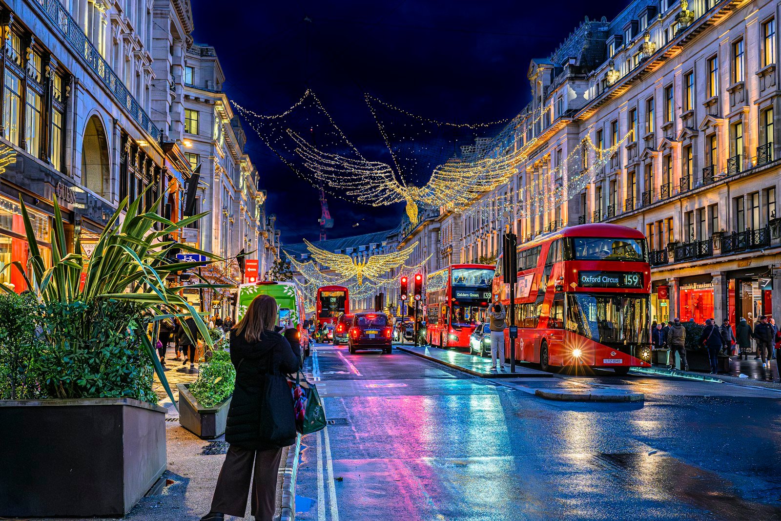 A London street decorated with Christmas lights at night